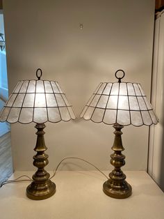 two lamps sitting next to each other on a table