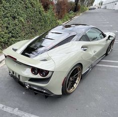 a white sports car parked in a parking lot