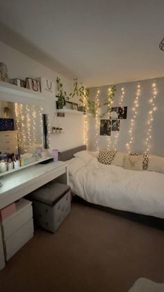 a bedroom with lights hanging from the ceiling and a bed in front of a mirror