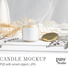 candle mockup with smart object jpg displayed on white tablecloth and dried wheat