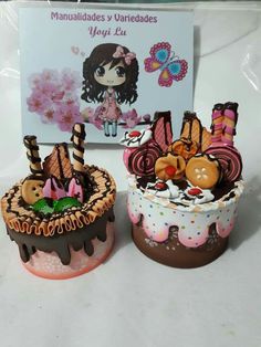 two decorated cakes sitting next to each other on a table