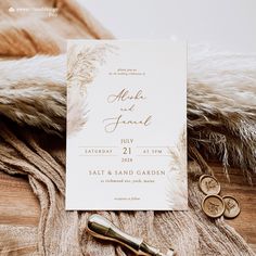 a wedding card and two gold coins on a furnishing area next to a pair of scissors