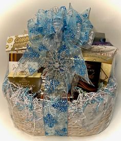 a blue and white gift basket filled with chocolates