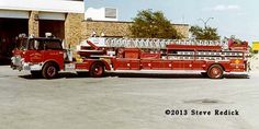 a red fire truck parked in front of a building