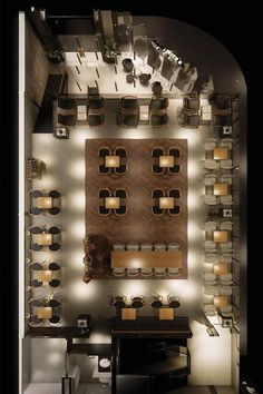 an overhead view of a dining room with lights on the wall and wooden tables in the center