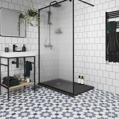 a black and white tiled bathroom with a walk in shower