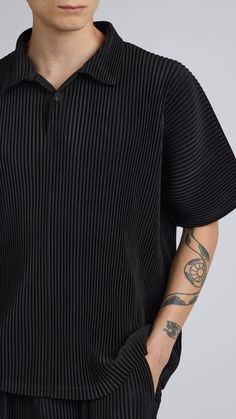 One Size. Fits XS-LColor: BlackPleated MaterialQuarter Button UpShort Sleeve100% PolyesterDry Clean OnlyBy The NKC Store Product MeasurementsChest: 132cm / 52inLength: 66.04cm / 26in Model is 185cm / 6'1" wearing size O/S Black Polo Shirt With Placket, Modern Black Polo Shirt With Collared Neckline, Black Polo Shirt With Button Closure, Black Relaxed Fit Tops With Buttons, Black Top With Johnny Collar, Black Summer Polo Shirt With Collared Neckline, Black Top With Johnny Collar And Ribbed Detail, Black Button-up Top With Placket, Modern Black Tops With Collared Neckline