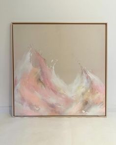 an abstract painting is hanging on the wall