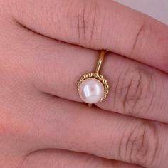 This lovely cultured pearl ring is the perfect gift for a loved one or a great self purchase. The nice size pearl has a gold beading design that is very simple but elegant. The pearl is the most desirable color with a nice white color with rose hues. This ring is a size 6.5 but is sizable. Just let our shop know what size your need and our in house jeweler can take care of that. The details for this beautiful ring are listed below:Metal Quality: 14 K Yellow Gold Gemstone: Freshwater Pearl Gemsto Senior Ring, Senior Rings, Beaded Frame, Beading Design, Cultured Pearl Ring, Frame Ring, Bead Frame, Pearl Rings, Star Jewelry