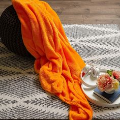 an orange towel on top of a white plate