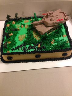 a cake in the shape of a tank with green frosting