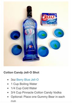 a bottle of blue jell - o next to cups and candy