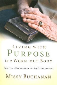 an older woman's hands resting on a book with the title living with purpose in a worn - out body