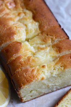 a loaf of lemon pound cake next to a slice of lemon