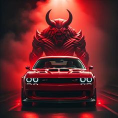 a red car in front of a demon with its headlight on and fog coming from behind it