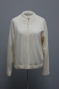 "DESCRIPTION: Cream sequined cardigan sweater Fully lined Sequins at shoulders, down front, along bottom, sleeve edges and in random areas on the body of the garmet Round neckline Long sleeves TAG/LABEL:  Sz 40 APPROXIMATE MEASUREMENTS (Measured Flat): Bust:  44\" Sleeve Length:  24\" Armhole:  8\" Shoulder to Shoulder:  15\" Length:  24\" CONDITION:  I found no issues." Cream Sweater Cardigan, Sequin Cardigan, Cream Cardigan, Round Neckline, Product Description, Sweater Cardigan, Sweater Outfits, Sleeve Length, Gender Neutral