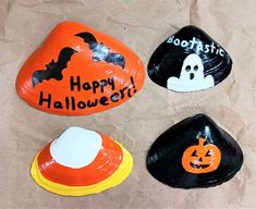 three painted rocks with halloween decorations on them