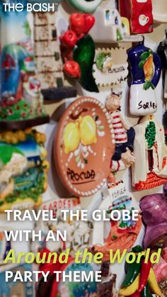 there is a wall full of magnets that say travel the globe with an around the world party theme