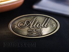 a metal name plate sitting on top of a table