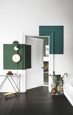 an open door in a white room with green accents