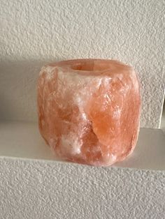 a donut sitting on top of a white shelf