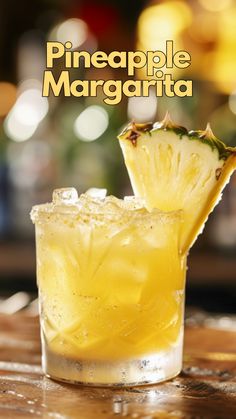 a pineapple margarita sitting on top of a wooden table