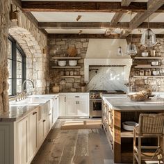 a rustic kitchen with stone walls and wood flooring is pictured in this image, there are several hanging lights above the sink