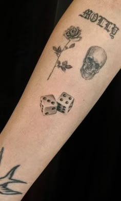 a tattoo with dices and skulls on it