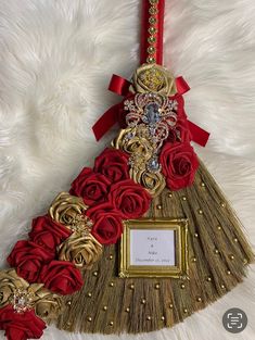 a red and gold christmas tree ornament with roses