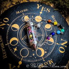 a pen with seven chakras on it sitting on top of a clock face