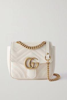 Gucci's 'GG Marmont' collection continues to grow with the addition of this compact shoulder bag. Made from matelassé leather featuring the brand's recognizable zigzag quilting, it's embellished with a gold-tone logo at the front flap and has an adjustable chain-trimmed strap that can be worn cross-body or doubled up. Gucci Soft Leather Crossbody Shoulder Bag, Gucci Soft Leather Shoulder Bag, Gucci Soft Leather Top Handle Shoulder Bag, Designer Gucci Shoulder Bag In Soft Leather, Designer Gucci Soft Leather Shoulder Bag, Gucci Soft Leather Crossbody Bag, Designer Gucci Soft Leather Bag, Designer Gucci Bag In Soft Leather, Luxury Gucci Shoulder Bag In Soft Leather