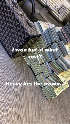 a pile of money sitting on top of a wooden table