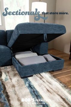 a blue couch with its storage compartment open