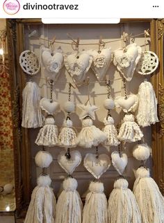 there are many tassels hanging on the wall in front of a mirror with an ornate frame