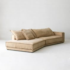 a large sectional couch with pillows on it