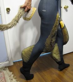 a person in tights is pulling something out of the closet with his hands and legs