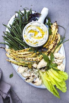 an assortment of vegetables and dip on a plate