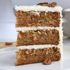 three slices of carrot cake on a white plate