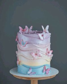 a multi layer cake with butterflies on it