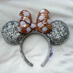 a minnie mouse ears headband with silver sequins