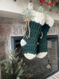 two christmas stockings hanging from a fireplace mantel