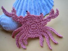 two crocheted sea animals laying next to each other on top of a table