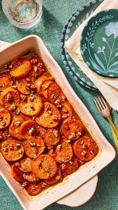 a casserole dish filled with sliced tomatoes