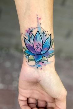 a lotus flower tattoo on the wrist