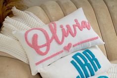 two pillows that are sitting on top of a couch with the words, elvina and arr