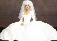 a woman in a white wedding dress and veil