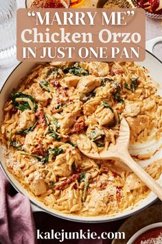 a large pan filled with chicken and spinach on top of a table