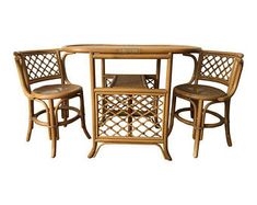 three chairs and a table made out of bamboo