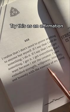 an open book sitting on top of a table next to a pen and paper with the words try this as an affirmation