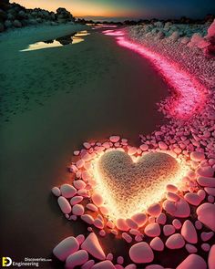 a heart made out of rocks on the beach